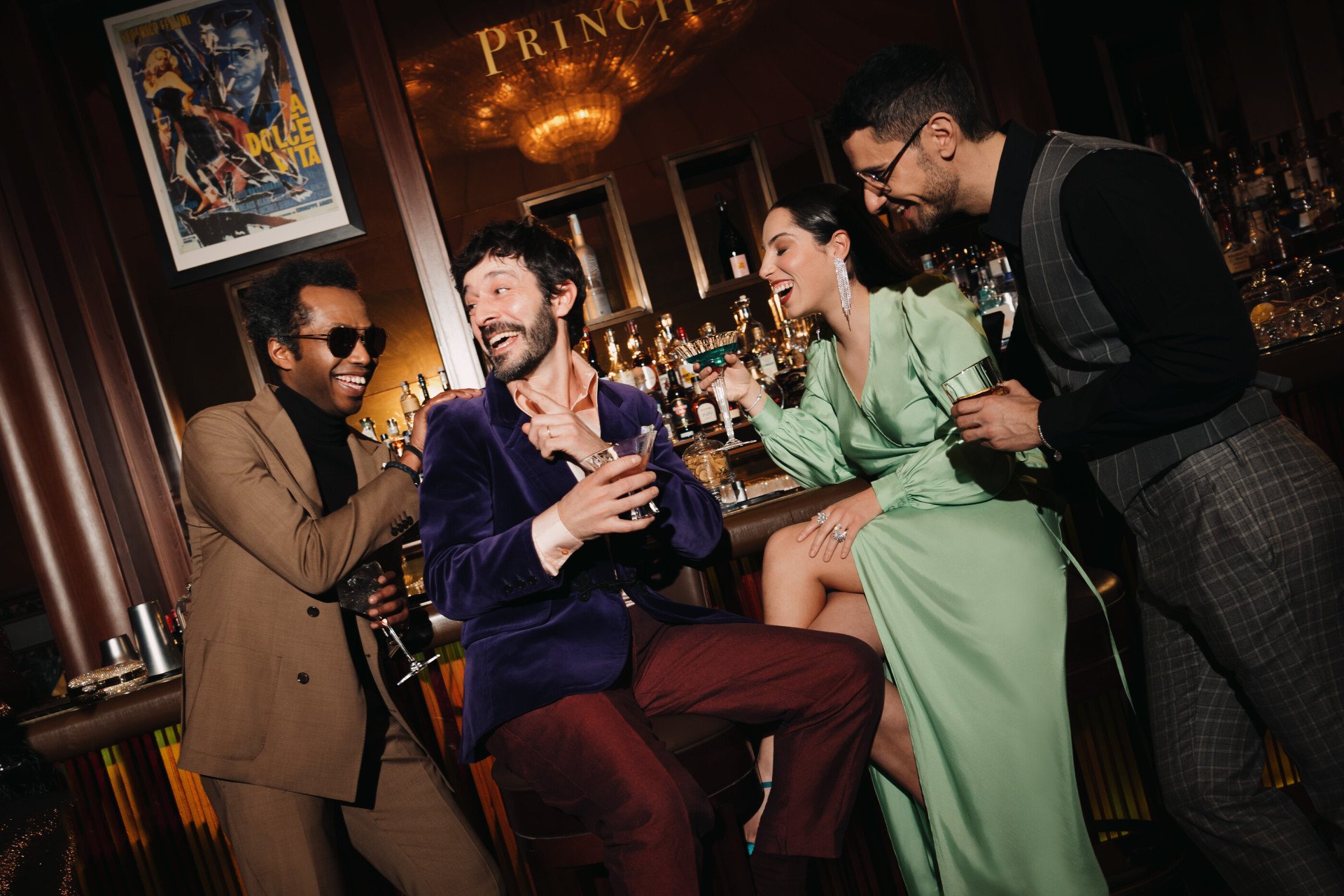 A group of people celebrating and drinking cocktails at Principe Bar 