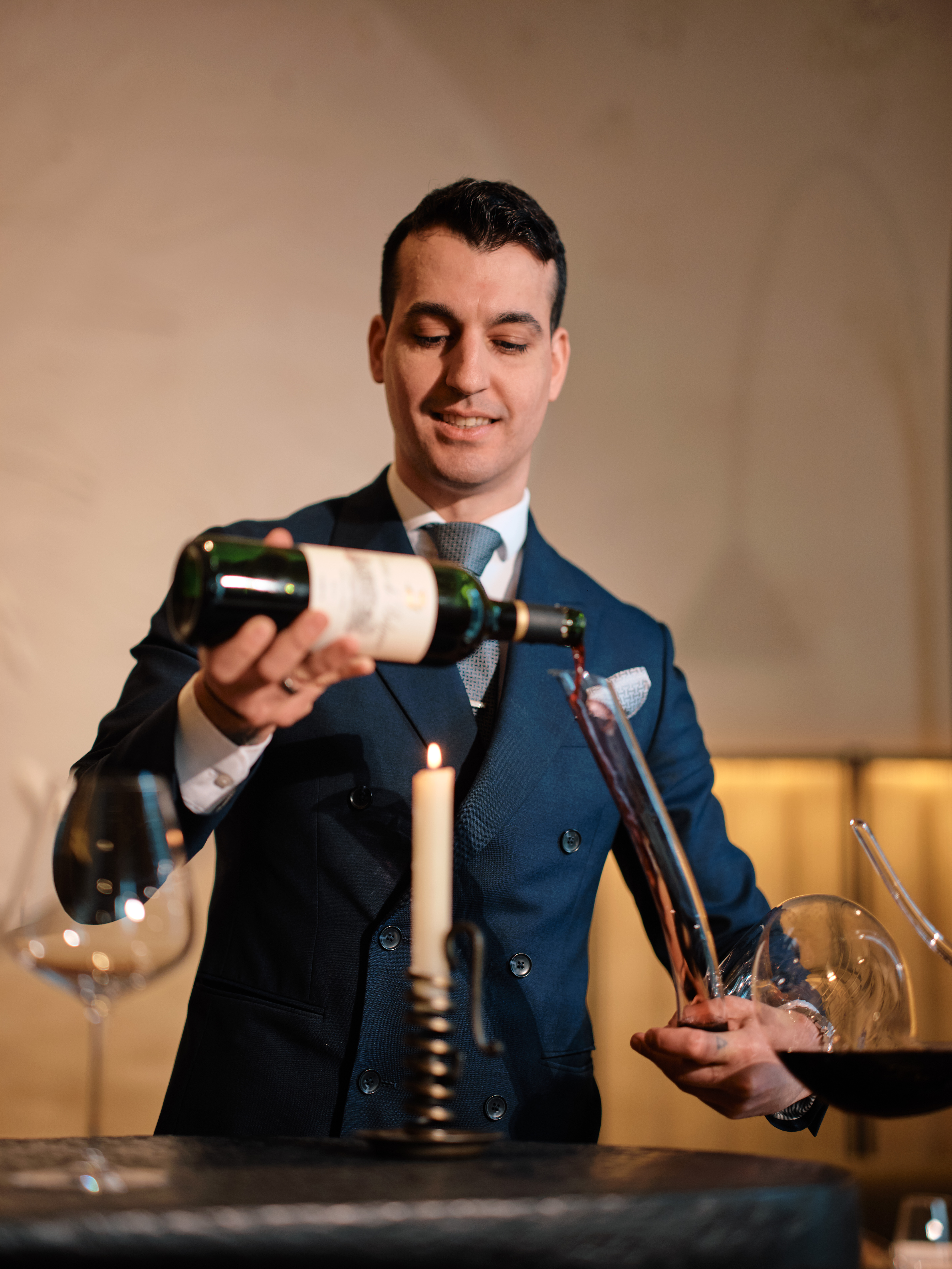 Sommelier decanting red wine at Woven by Adam Smith, Coworth Park