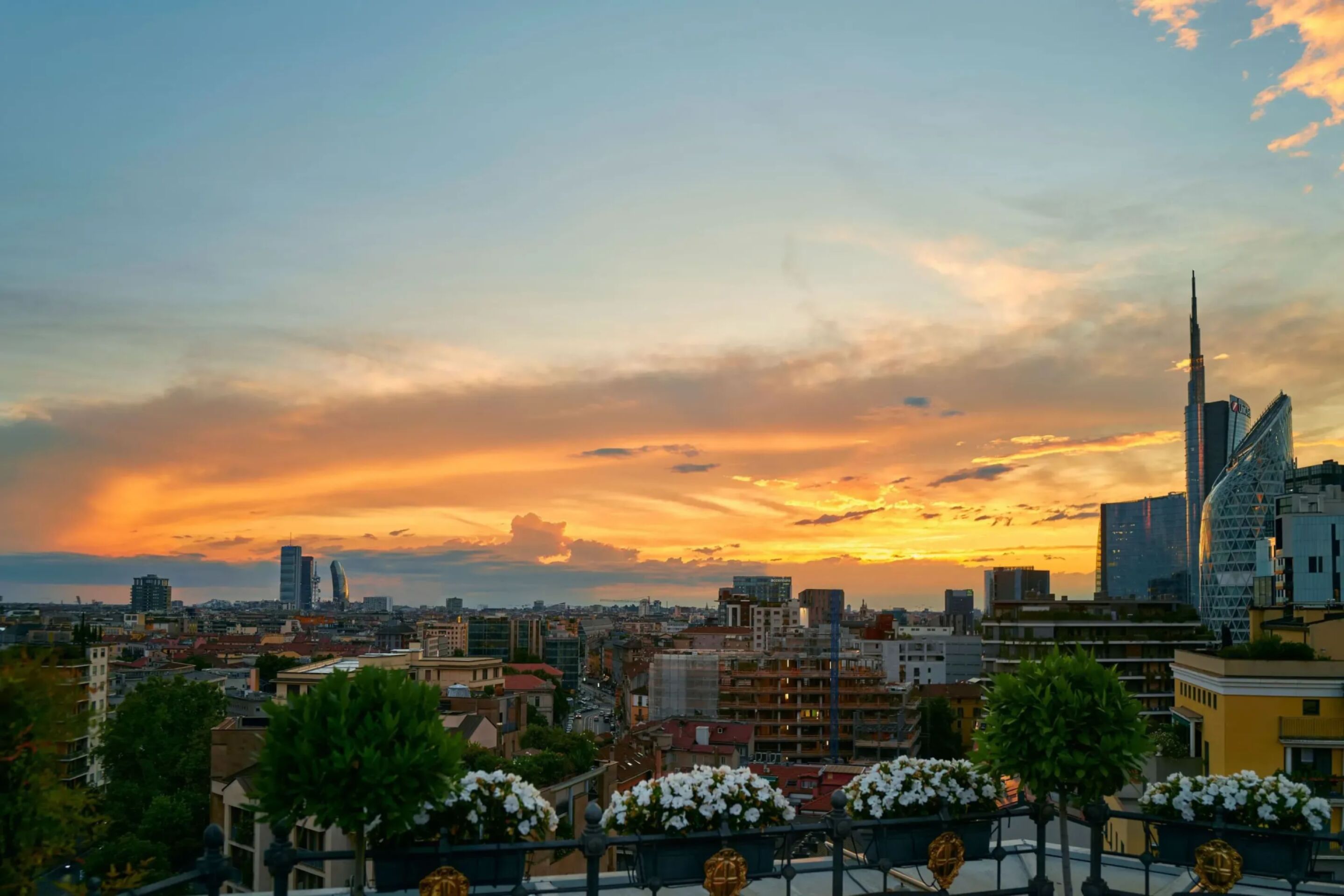 view from Hotel Principe di Savoia rooftop on Porta Nuova district with sunset