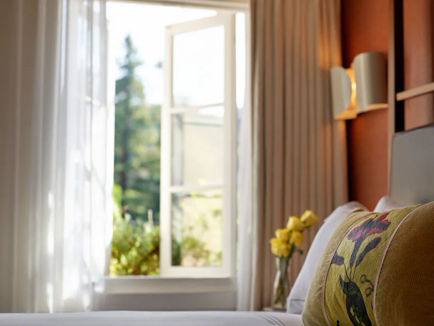 Detail shot of the surface of a bed with a window in view from a Canyon Suite at Hotel Bel-Air.