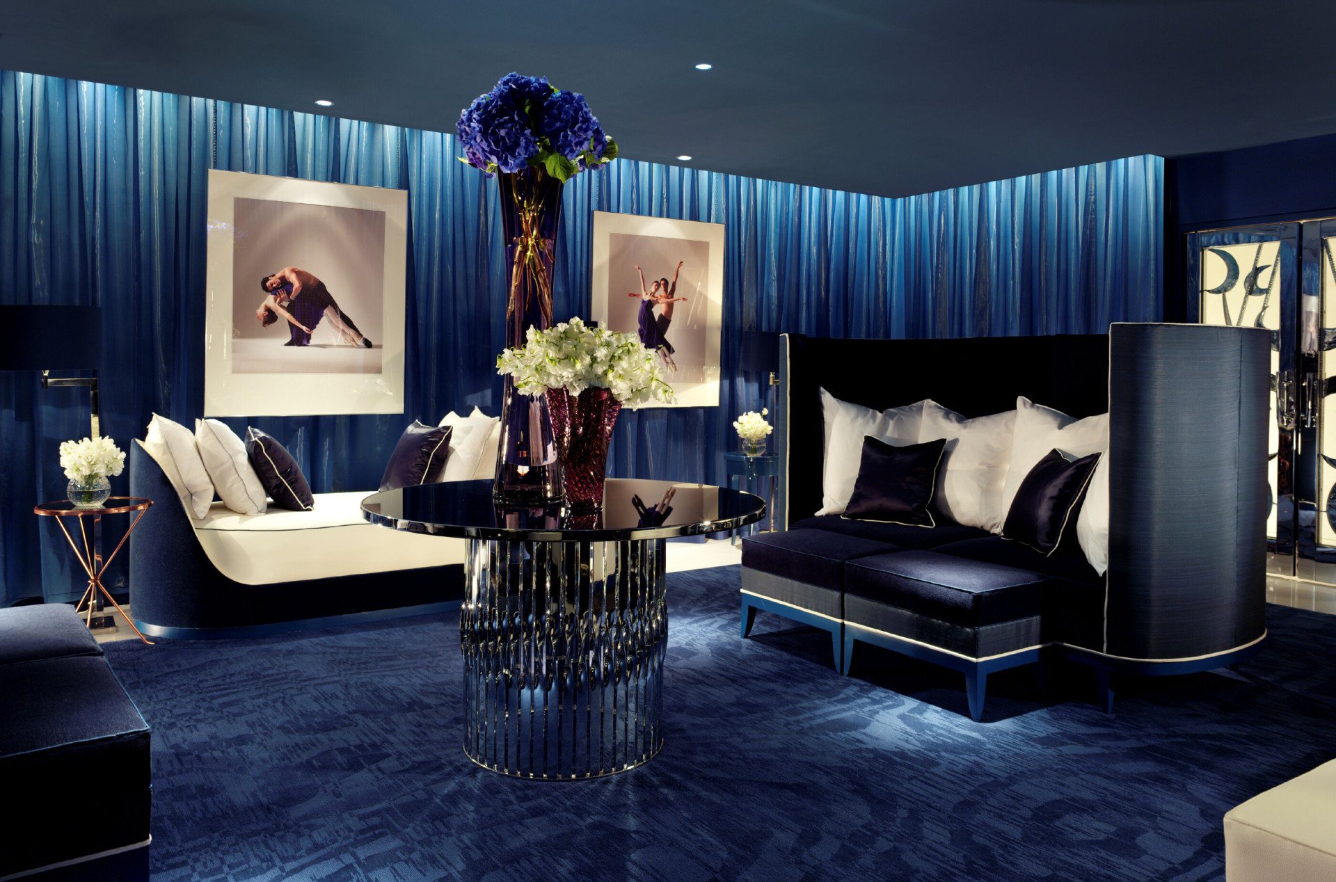 A welcoming, comfortable low-lit room in deep blue tones