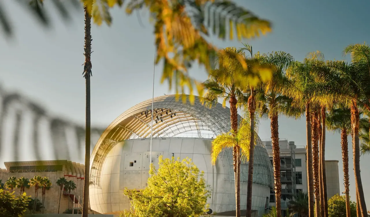 Architectural exterior and palm trees around of the Academy of Motion Pictures Museum in Los Angeles