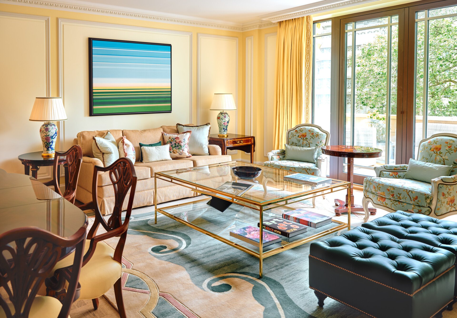 A classically elegant room in cream tones with a vibrant piece of artwork
