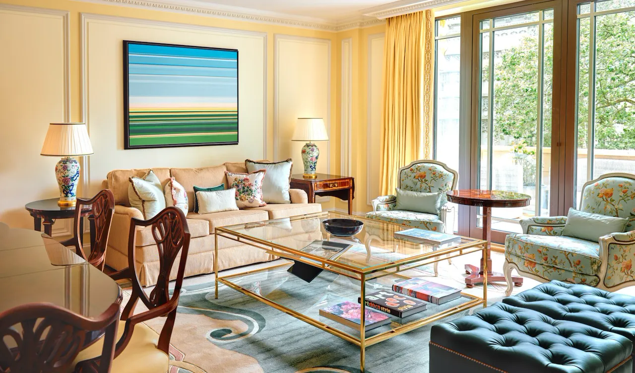 A classically elegant room in cream tones with a vibrant piece of artwork
