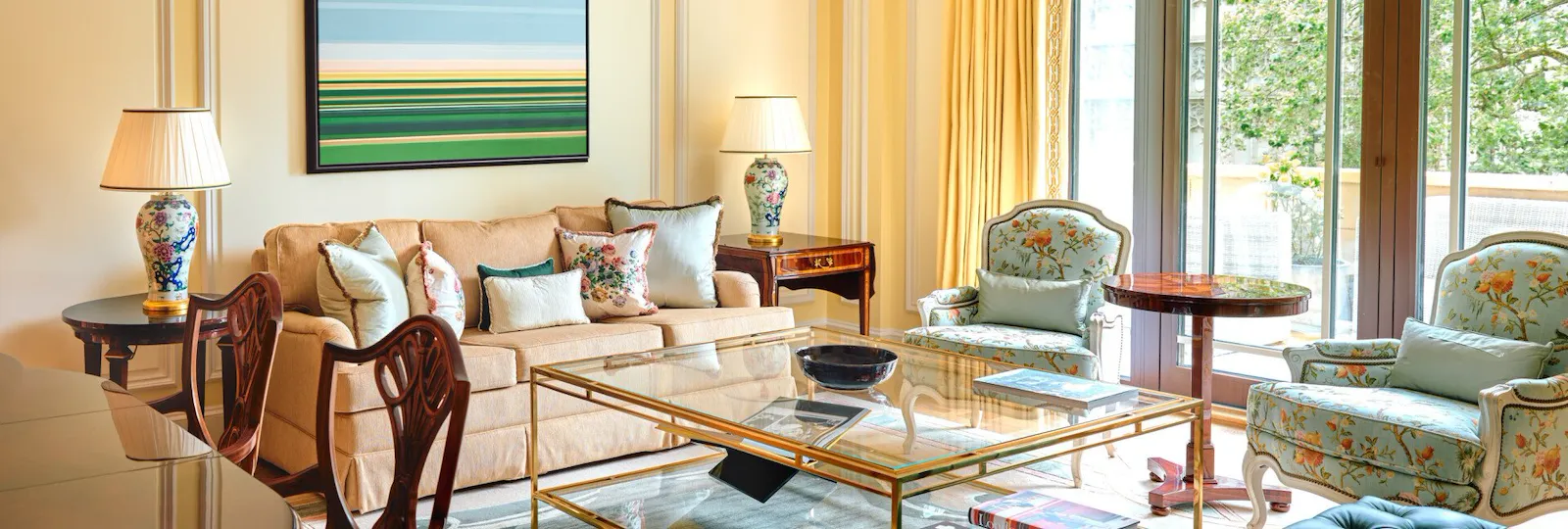 A classically elegant room in cream tones with a vibrant piece of artwork