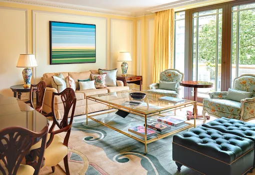 A classically elegant room in cream tones with a vibrant piece of artwork