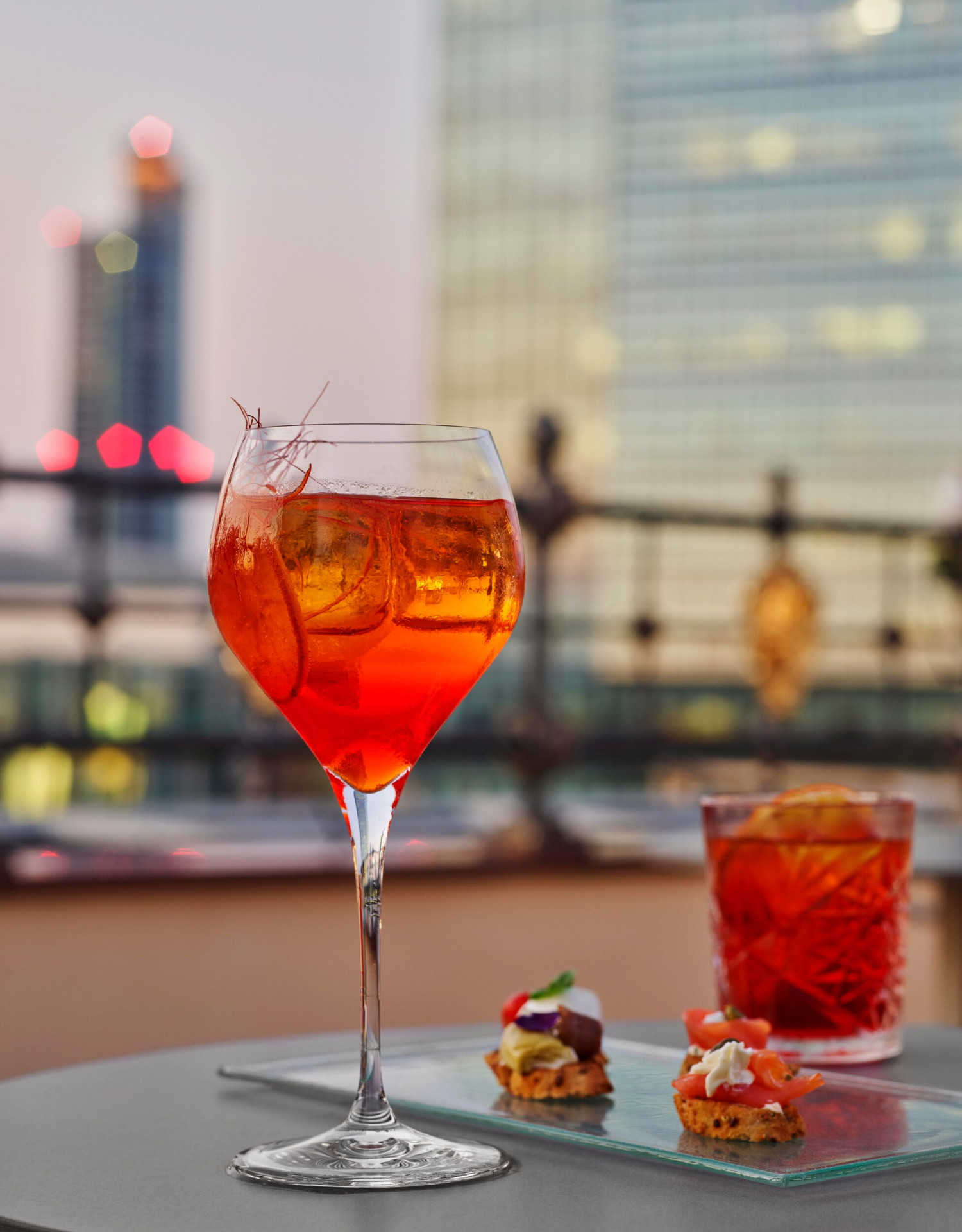 Aperitif on the rooftop terrace of Club 10 Fitness & Beauty Center with a detail on Spritz cocktail and canapes