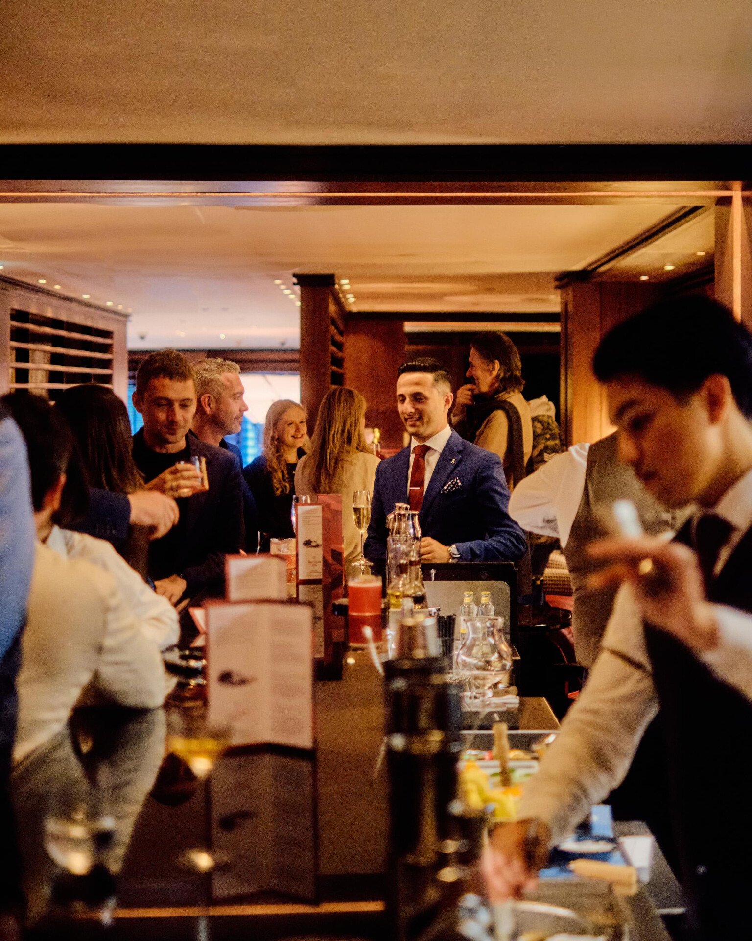 The Macallan Party at 45 Park Lane guests having a great time at night in Bar 45 with bartenders making cocktails