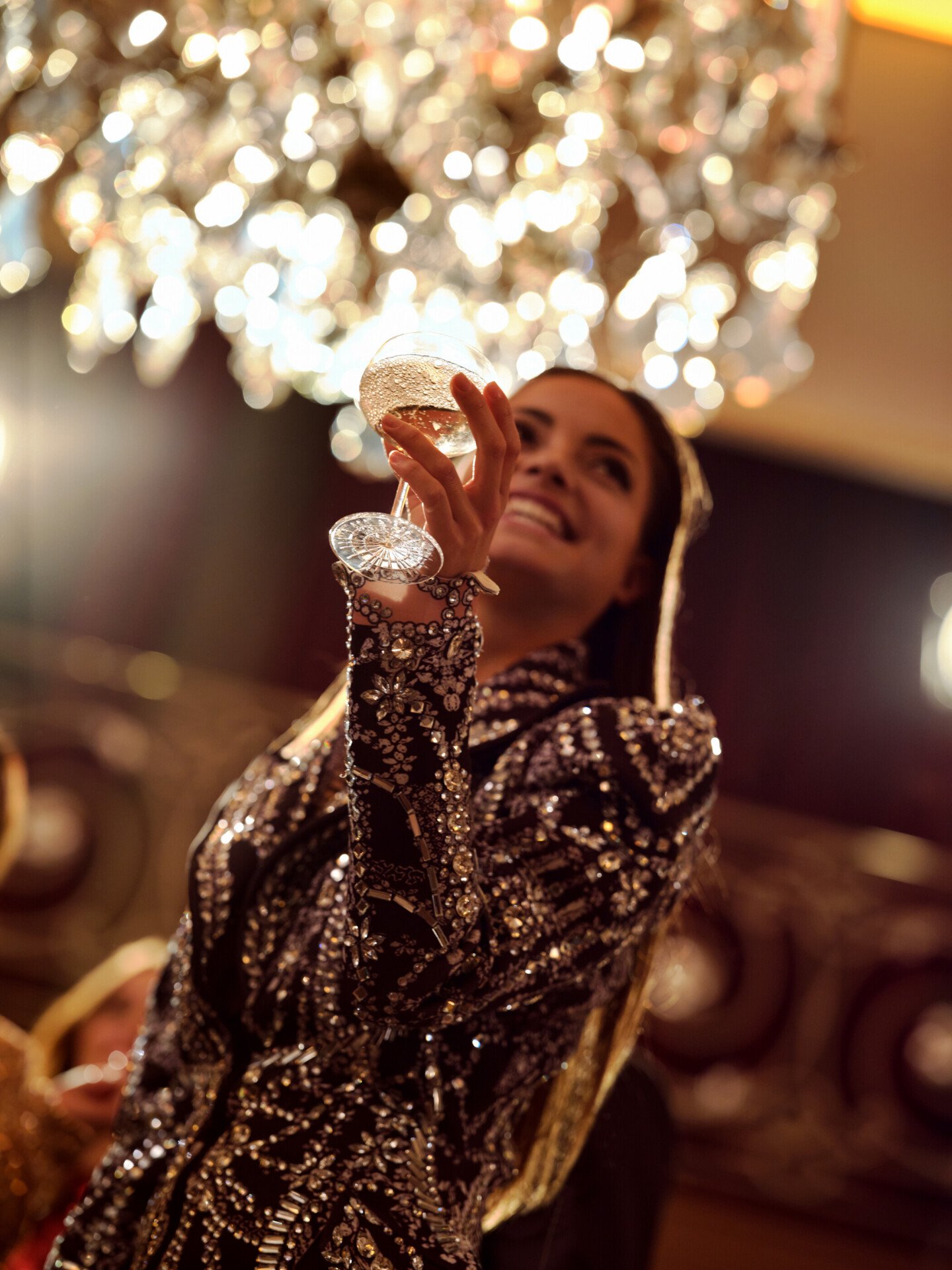 Woman with her glass in Le Salon Haute Couture, at Hôtel Plaza Athénée, Paris - Dorchester Collection.