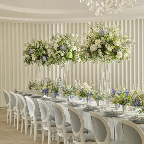 The Oval Room at Coworth Park styled for a social event with elegant floral arrangements