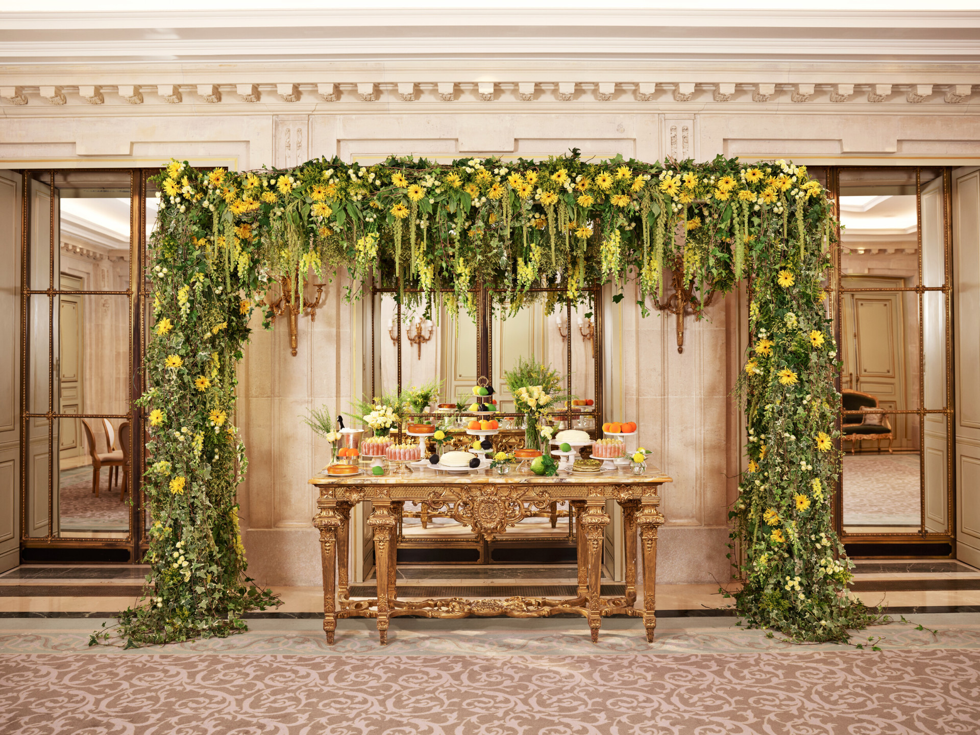Pastry table for private dinner in Salon Tuileries, with green and yellow floral arch, at Le Meurice, Paris - Dorchester Collection