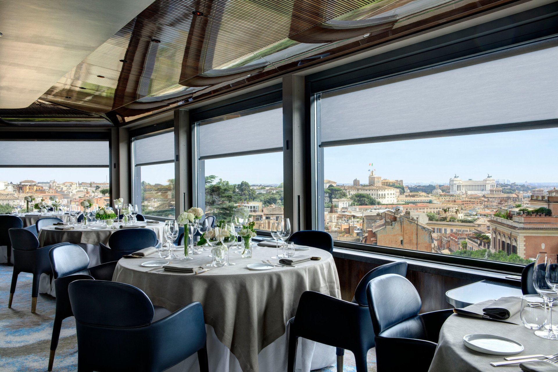 Private dining event at La Terrazza with flower display on tables and view of Rome at Hotel Eden