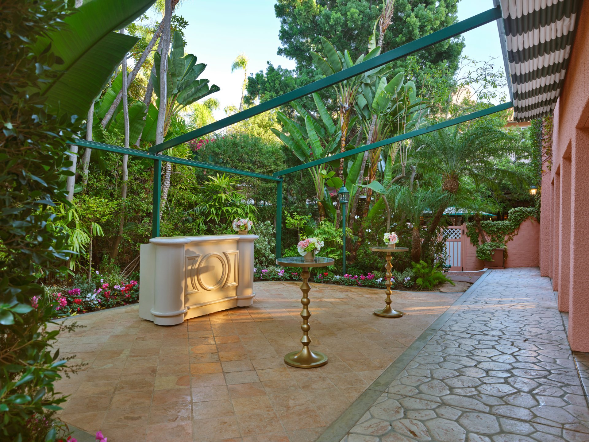 Garden decorated with candles and flowers on a sunny outdoor patio.