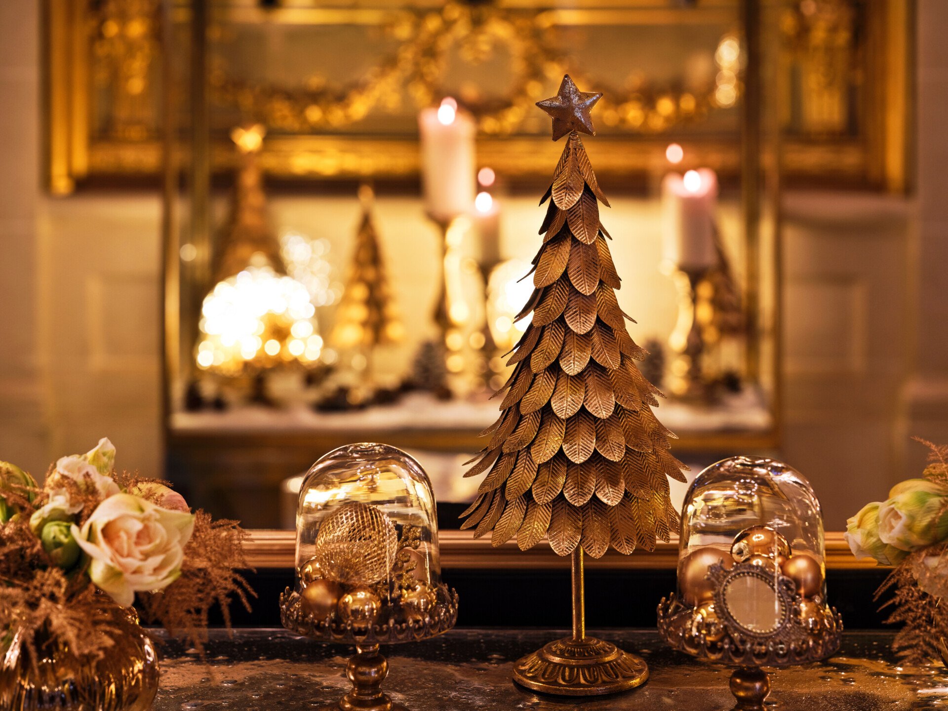 Focus on some Christmas decorations in gold like short Christmas tree, christmas ornaments and flowers, at Le Meurice, Paris
