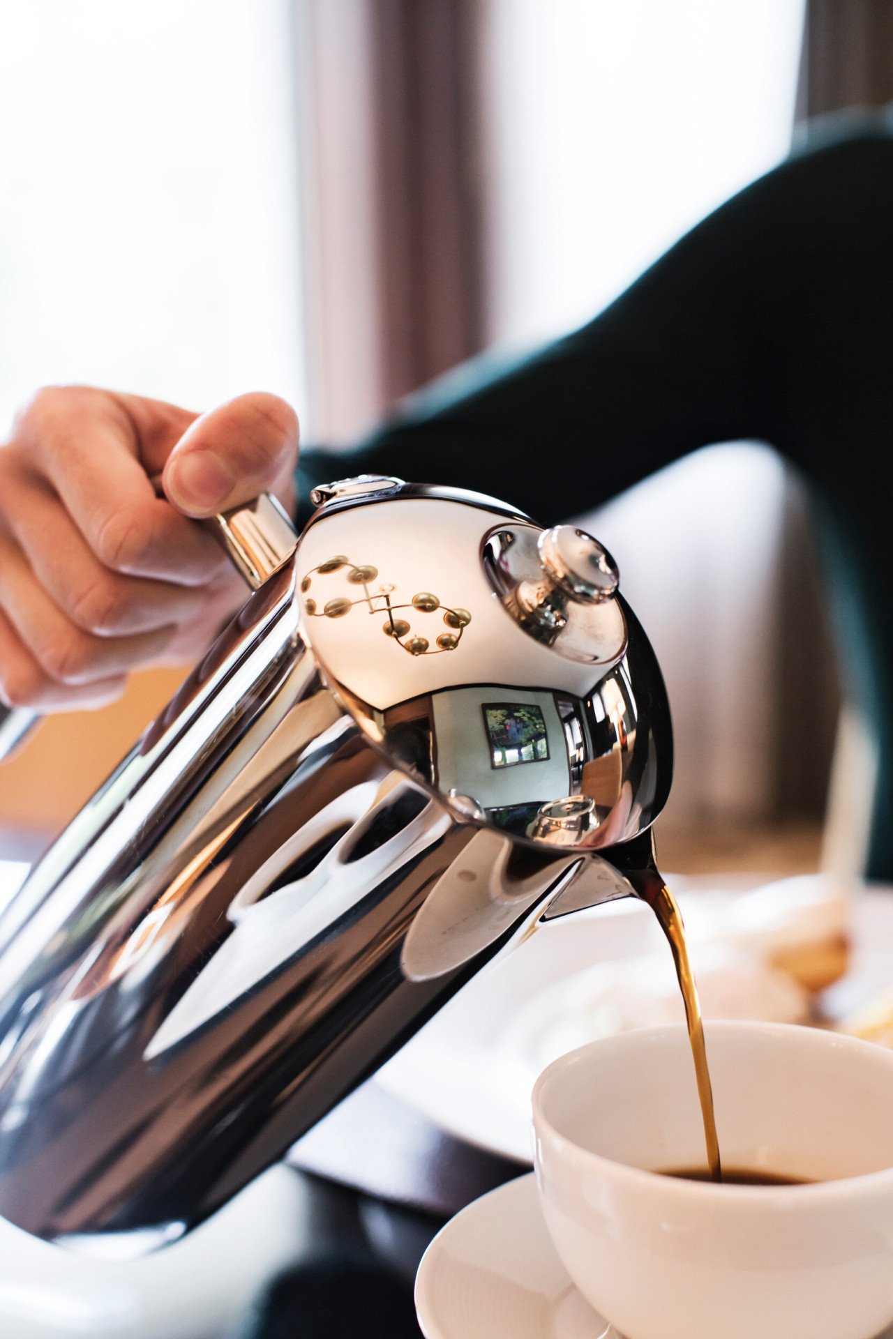 Coffee being poured into a cup by butler service at 45 Park Lane