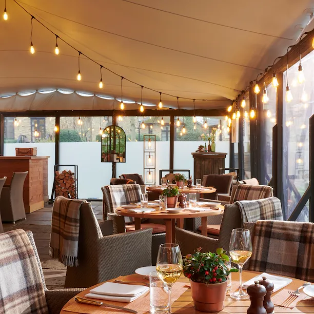 Coworth Park, The Barn, winter, terrace room dressed for dinner service with winter light