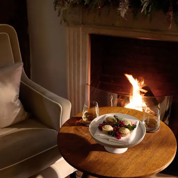 festive dining at Coworth Park in front of a fireplace
