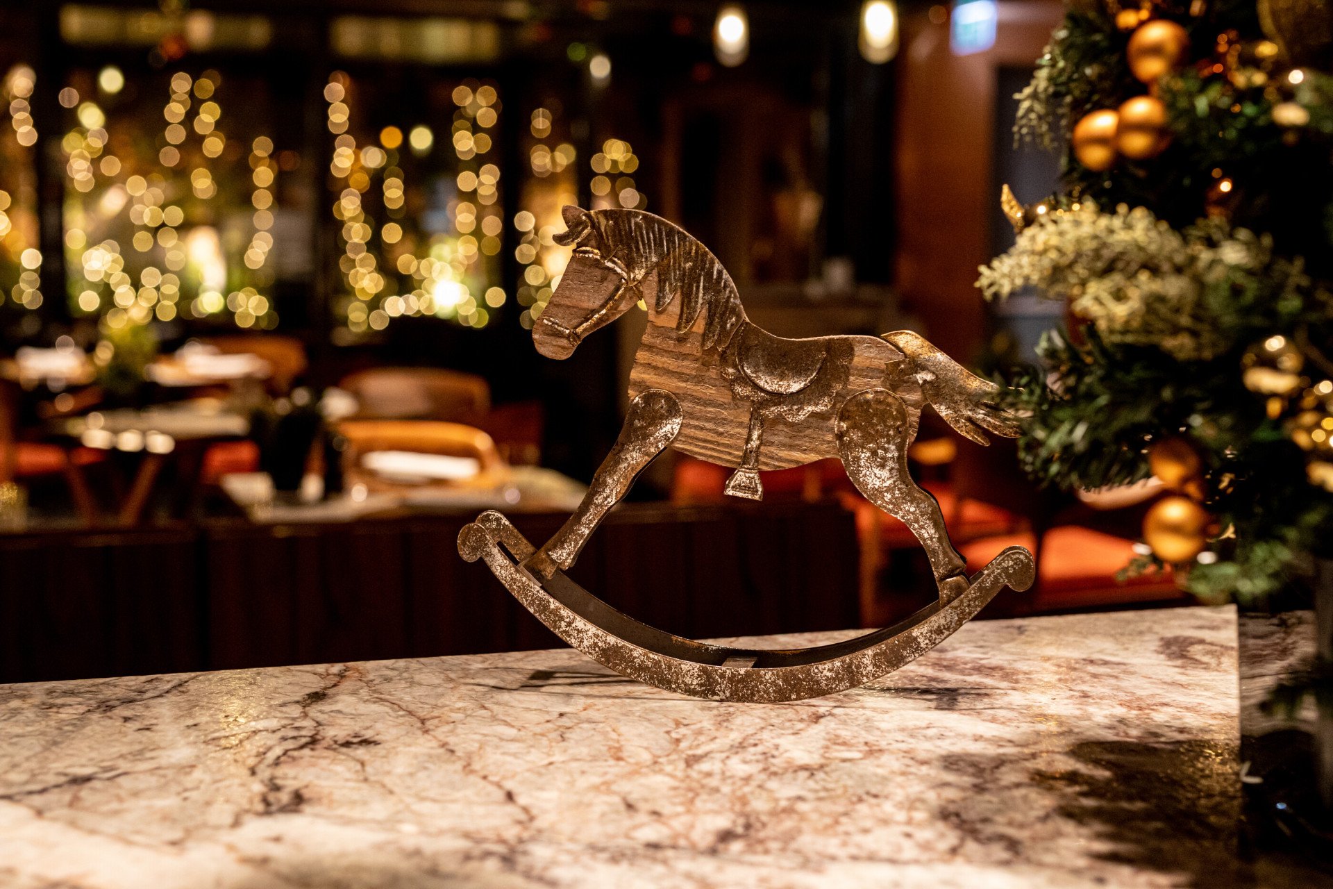 Christmas horse decoration and fairy lights in the background at Il Giardino Ristorante at Hotel Eden, Rome