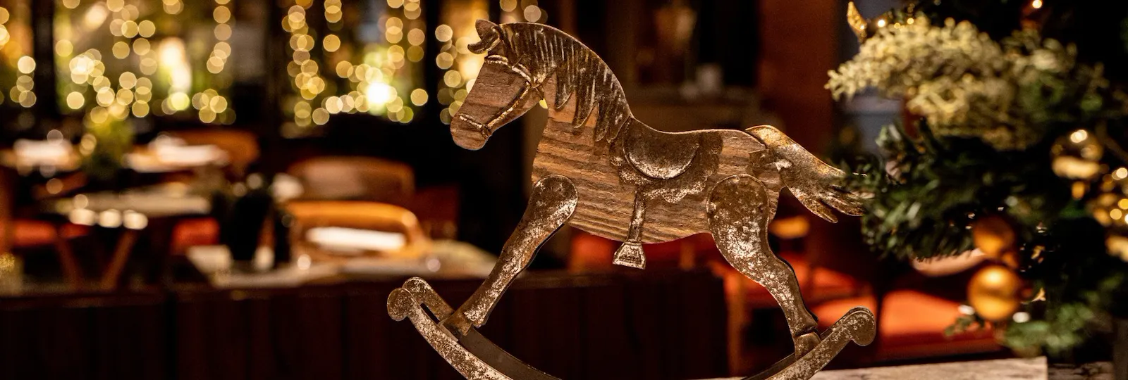 Christmas horse decoration and fairy lights in the background at Il Giardino Ristorante at Hotel Eden, Rome