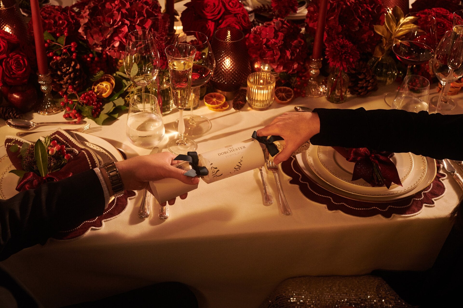 Festive Events at The Dorchester - Two guests pulling a Dorchester Christmas cracker