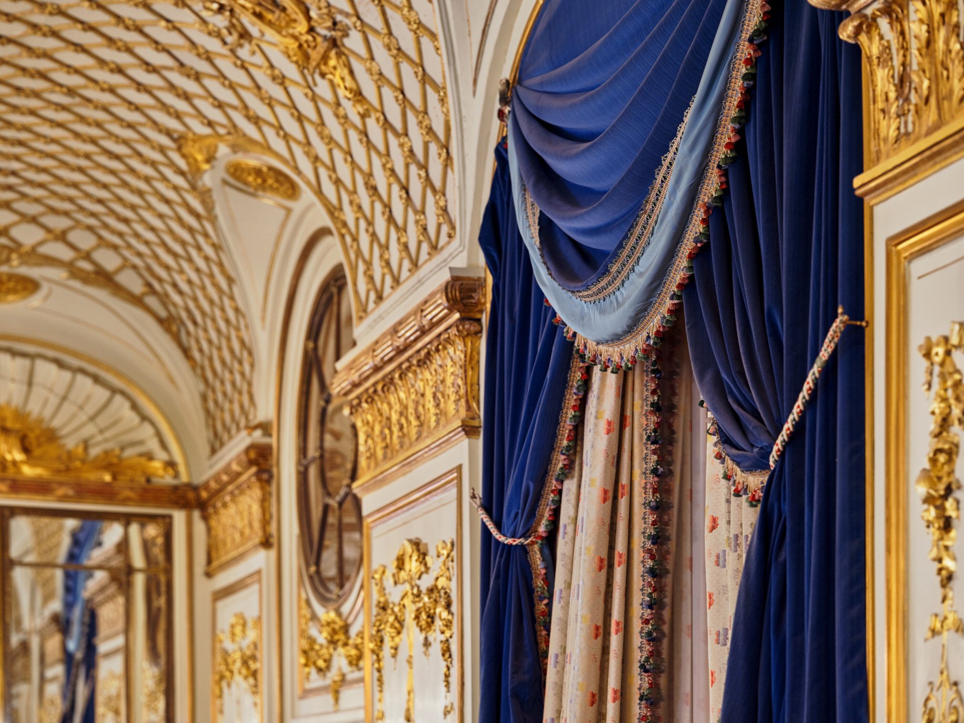 Details of the ceiling gilding, and the blue curtains, in Le Salon Pompadour at Le Meurice, Paris - Dorchester Collection