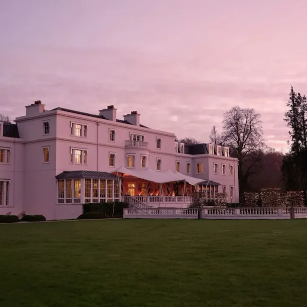 The exterior of the Mansion House at Coworth Park in the evening light