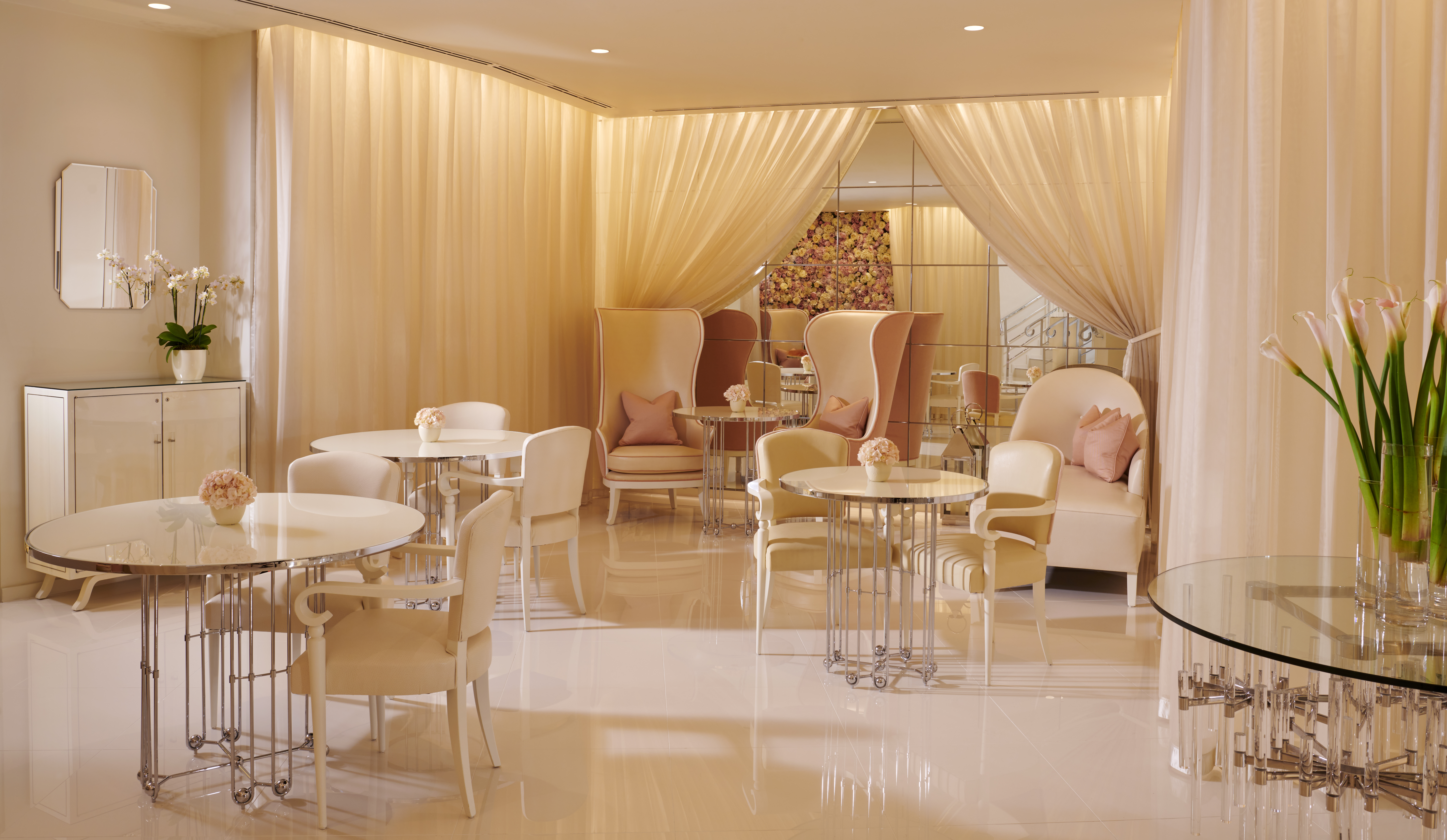 The Spatisserie at The Dorchester, featuring soft pink interiors, marble flooring and elegant blush pink armchairs.