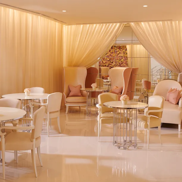 The Spatisserie at The Dorchester, featuring soft pink interiors, marble flooring and elegant blush pink armchairs.
