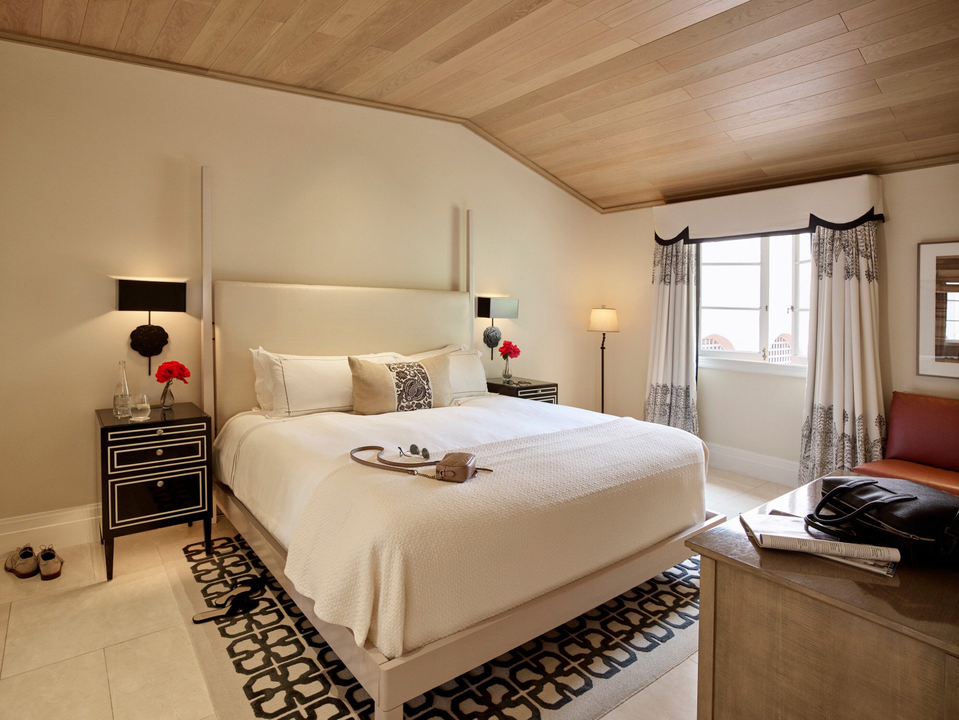 View of the second bedroom in the 2 bedroom Bel-Air Suite highlighting the spacious area, bed, and natural light that comes through the large window adjacent to the bed. 